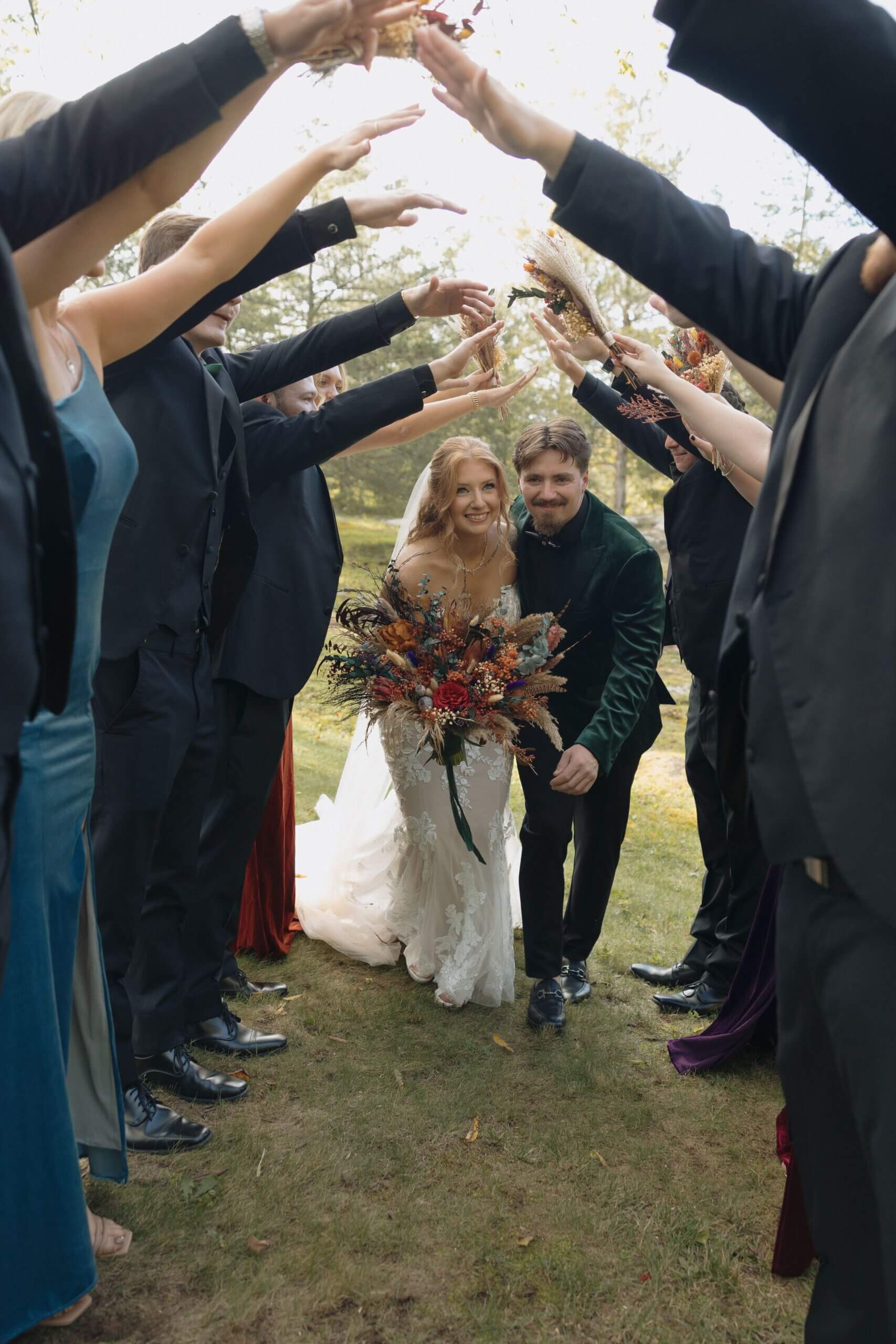 Newlywed couple going through tunnel of wedding party celebration.
